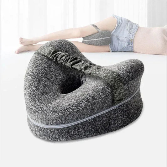 Gray footrest with person lying on a white surface